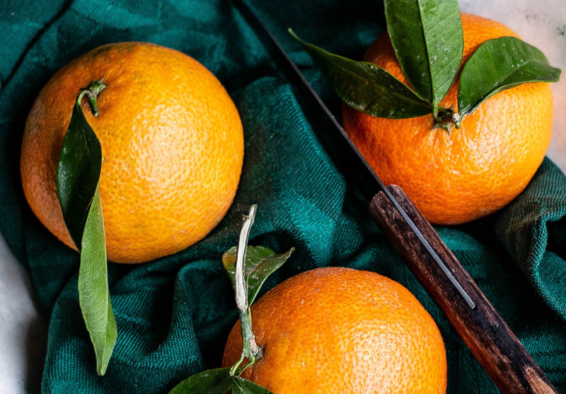 closeup of oranges and a knife