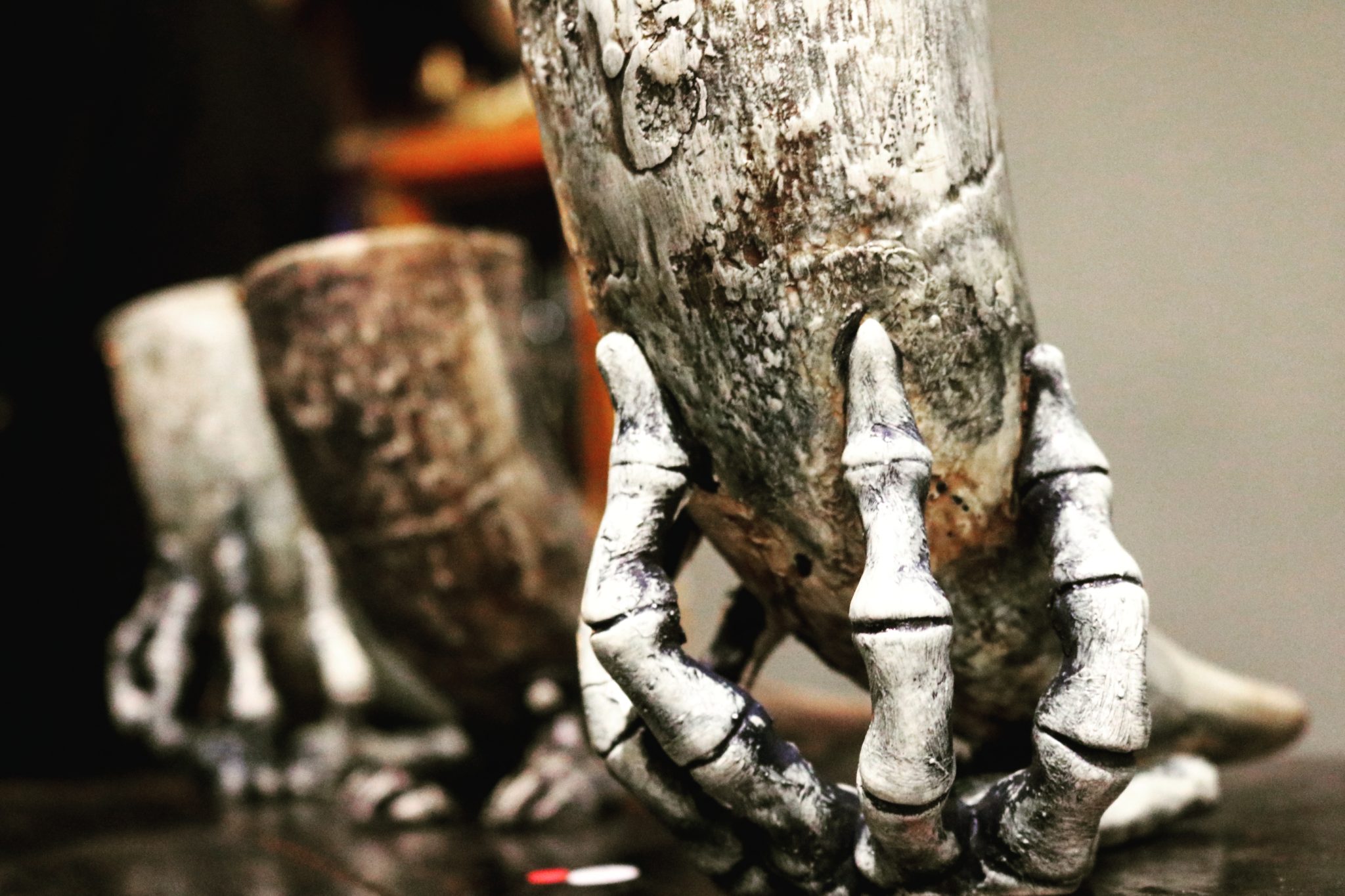 A skeleton hand holding a horn tiki mug